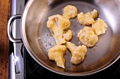 Cauliflower being roasted in pan, step 2