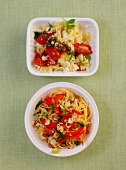 Pasta salad and chilli noodles with nut and paprika in serving dishes