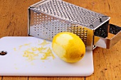 Lemon zest with lemon and grater on chopping board, step 2