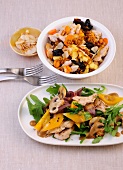 Turkey with couscous in bowl and vegetable salad with turkey on plate