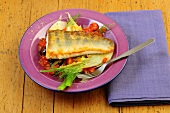 Zander with tomato and fennel on plate