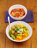 Lentil stew and carrot stew with marrow dumplings in bowls