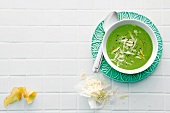 Potato and spinach soup with parmesan in bowl