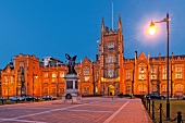 View of illuminated Belfast Queen's University at night, Belfast, Ireland, UK