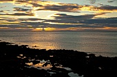View of Antrim Coast cliff and sea at sunset, Ireland, UK