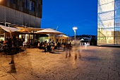 People sitting outside Waranga club lounge in Stuttgart, Germany, blurred motion