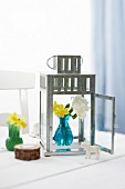 Grey garden lantern with blue vase