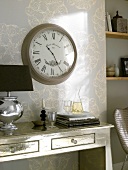 Antique wall clock on console