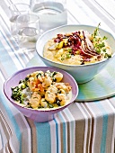 Polenta with vegetables and gnocchi with gorgonzola and spinach in bowls