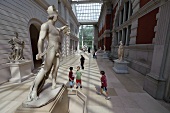 Children looking at statue in Metropolitan Museum of Art, New York, USA
