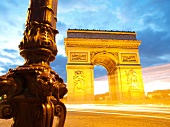 People walking in front of Arc de Triomphe on Place Charles de Gaulle in Paris, France