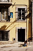 Girl playing on street of Alfama, Lisbon, Portugal