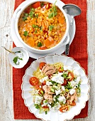 Red lentil soup in bowl and bulgur dish on plate
