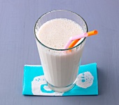 Banana and ginger mix in glass with straw