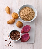 Potatoes, rice, lentils and meat on chopping board, food rich in vitamin B