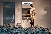Mannequin standing in front of ATM machine symbolizing love of money in New York, USA