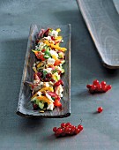 Farmer's salad with poppy seed oil dressing and redcurrants