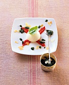 Tomato and mozzarella with basil pesto and vanilla oil on plate
