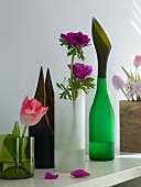 Vases made up from recycled material with flower stems