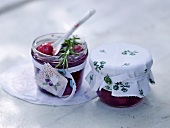 Preserving jars with pepper cherries garnished with rosemary