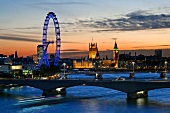 View of London Eye, Houses of Parliament, Big Ben and river Thames at dusk in London