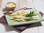Asparagus salad with cress and fork in serving dish