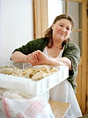 Portrait of noodle maker Antonett breeze with box of fettuccine nests, smiling