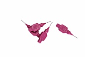 Pink interdental brushes on white background