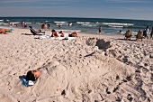 People relaxing on beach, New York, USA