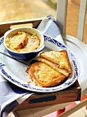 Onion soup served with croque-monsieur and au gratin on plate, France