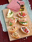 Bruschett smoked with salmon and strawberry on wooden platter