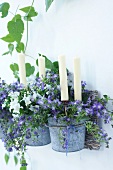 Lit candles in flower pots turned into candlestick