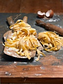 Fettuccine pasta on wooden board