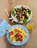 Conchiglie pasta with tomato and spinach omelette on plates