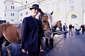 Woman standing besides horse at Cathedral Square, Salzburg, Austria