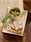 Ham jelly and parsley with pickles in serving dish, France