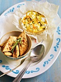 Camembert with walnut crackers and rosemary on plate, France