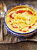 Potato gratin in serving bowl, France