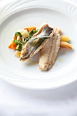 Close-up of whitefish with vegetables on plate