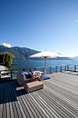 Man and woman sitting on terrace of Eden Roc hotel in Ascona near Lago Maggiore lake