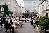 People sitting at coffee houses in the Old Market, Salzburg, Austria