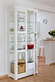 White china cabinet with crockery