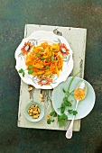 Thai mango carrot salad with peanuts on serving dish