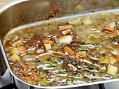 Close-up of mixture being boiled in pan for preparation of bratenjus, step 5