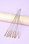 Close-up of acupuncture needles on purple background