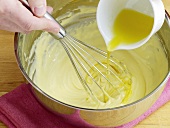 Lemon juice being added in mixture for preparation of hollandaise sauce, step 5