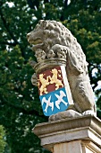 Close-up of stone lion with coat of arms at Baltic Coast mansion