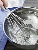 Close-up of vinegar being stirred with whisk in bowl, step 1