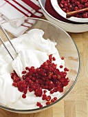 Cranberry and cream being mixed with spatula in bowl, step 2