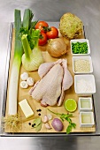 Poularde with basmati rice and other ingredients on wooden board for fricassee